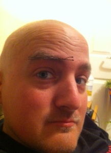 George with a hair clip in his bushy eyebrow