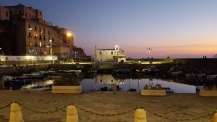 Evening shot of part of Pozzuoli port, with Rione Terra dominating on the left