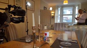 George's dining/living room with BBC crew and romantically laid-out dinner table