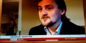 George on BBC News, with name captioned