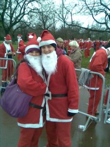 George and Mariacristina in Santa costumes for a fun run